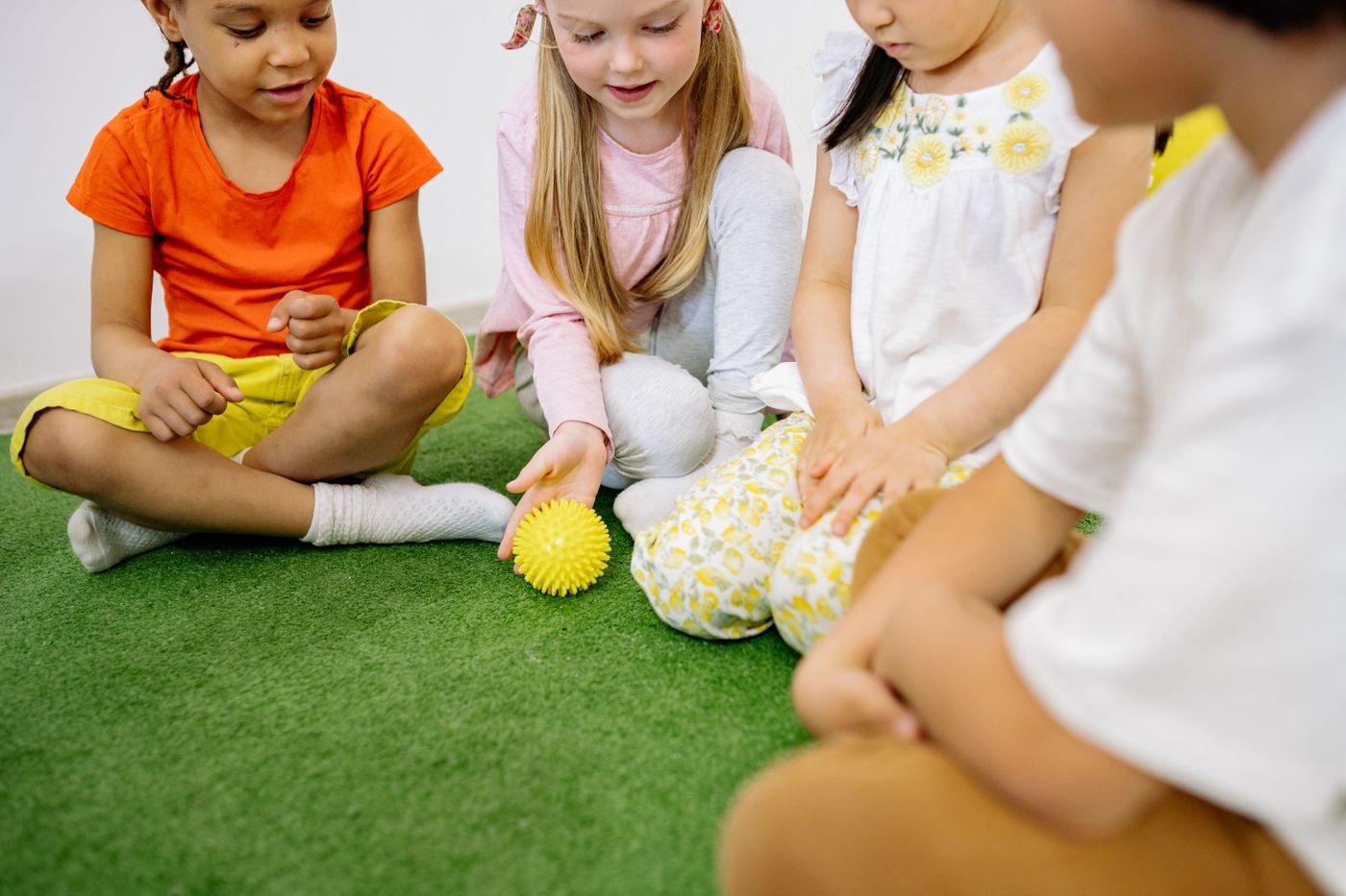 Preschool children playing a ball game together